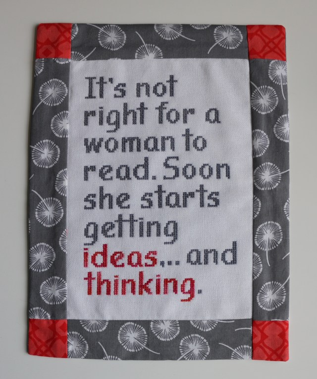 The Gospel according to Gaston: Finished piece in a patchwork frame.